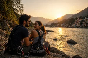 A couple sitting on a riverside cliff in Rishikesh after an adventure activity