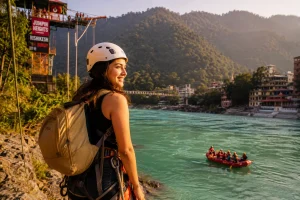 Solo woman traveler standing at the edge of a scenic Rishikesh riverbank